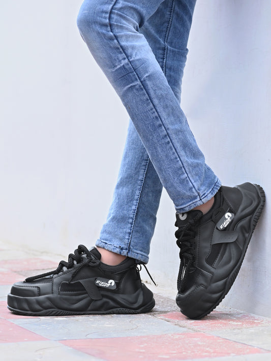 Mens comfortable black running shoes with cushioned sole worn with blue jeans outdoors