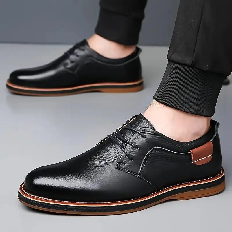 Comfortable men's lace up dress shoes in black leather with brown sole and stitching detail