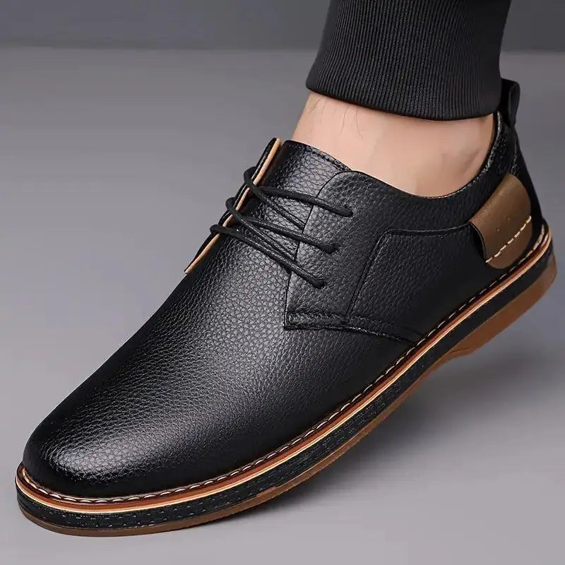 Black comfortable men's lace up dress shoes with brown sole and detailed stitching