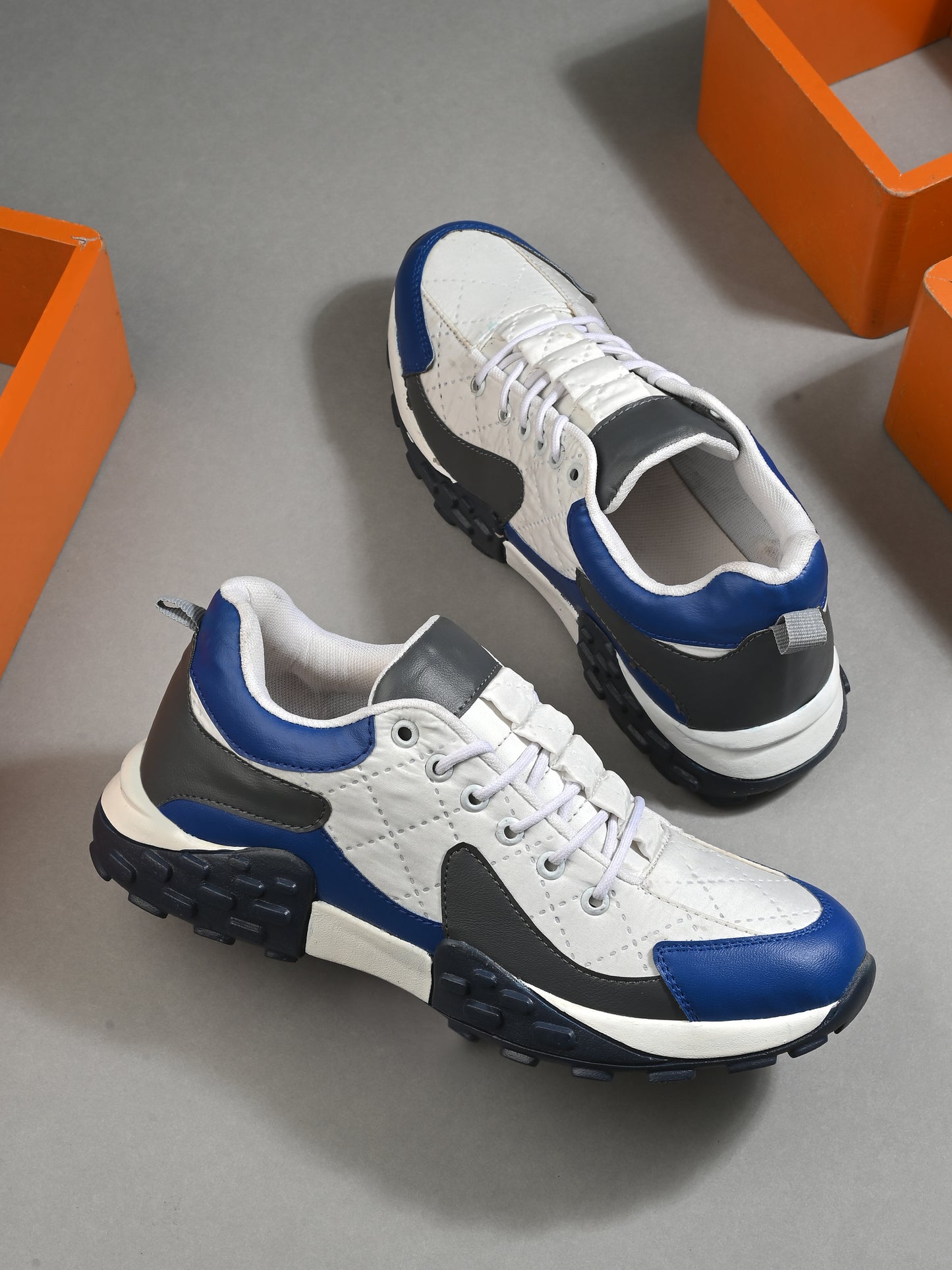 Men's casual comfortable white running shoes with blue and black accents and cushioned soles