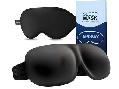 Black light blocking eye mask with contoured design and adjustable strap next to blue and white sleep mask box