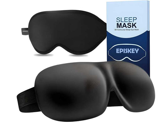 Black light blocking eye mask with contoured design and adjustable strap next to blue and white sleep mask box