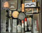 Full face makeup kit combo with foundation, lipsticks, eyelashes, primer, and setting spray