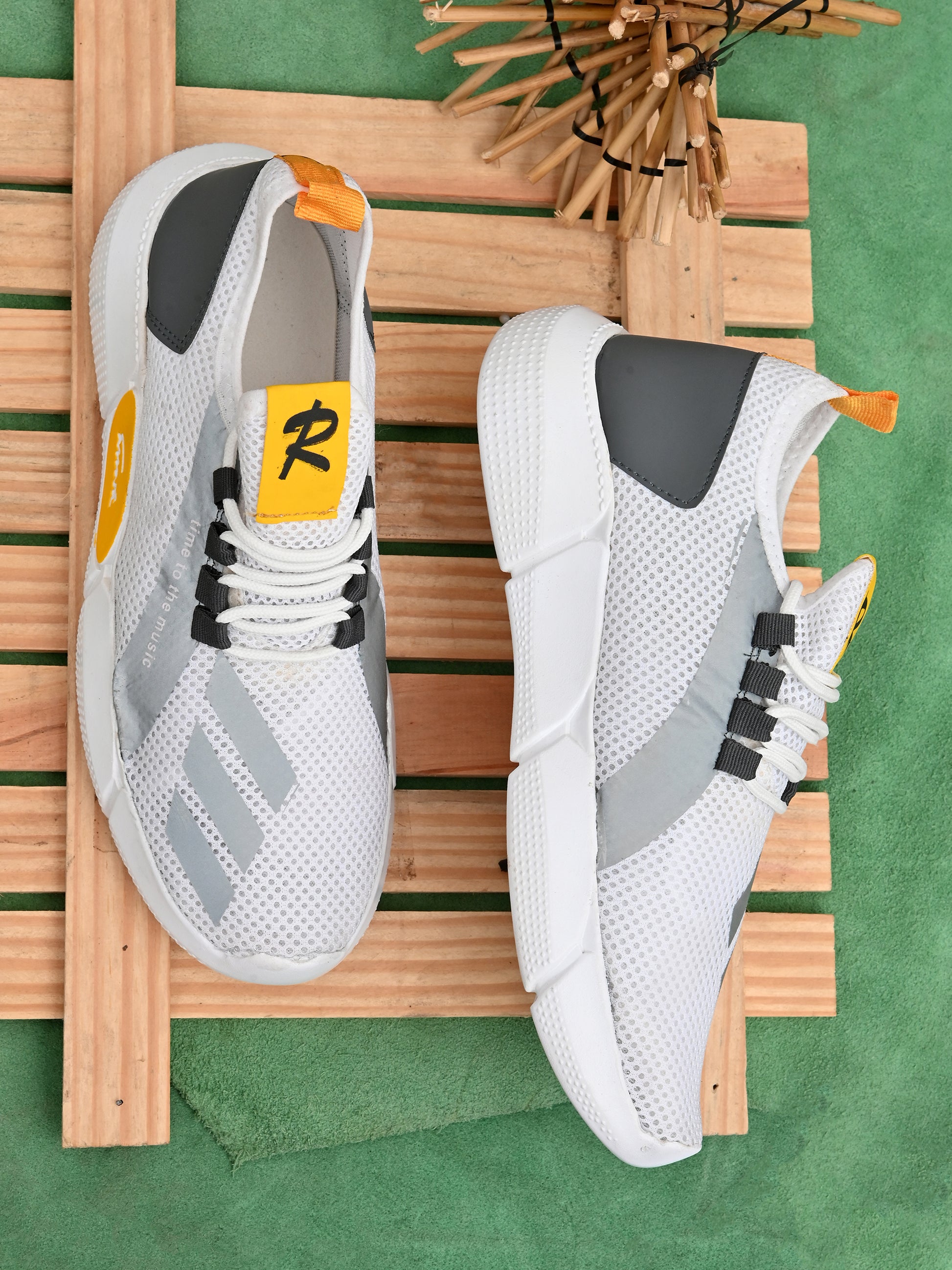White and gray lightweight casual sneakers for men with breathable mesh design and yellow accents