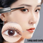 Woman applying mascara for curled lashes on long, defined eyelashes with close-up detail view