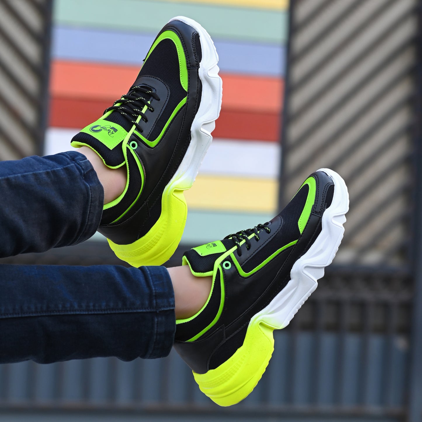 Lightweight green sports trainers for men with black and neon accents and thick white soles