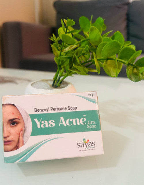 Dropdash Yas Acne 2.5% benzoyl peroxide face soap for acne treatment displayed near green plant