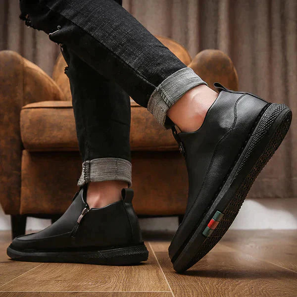 Mens casual black leather shoes with side zipper and comfortable sole worn with rolled-up black jeans